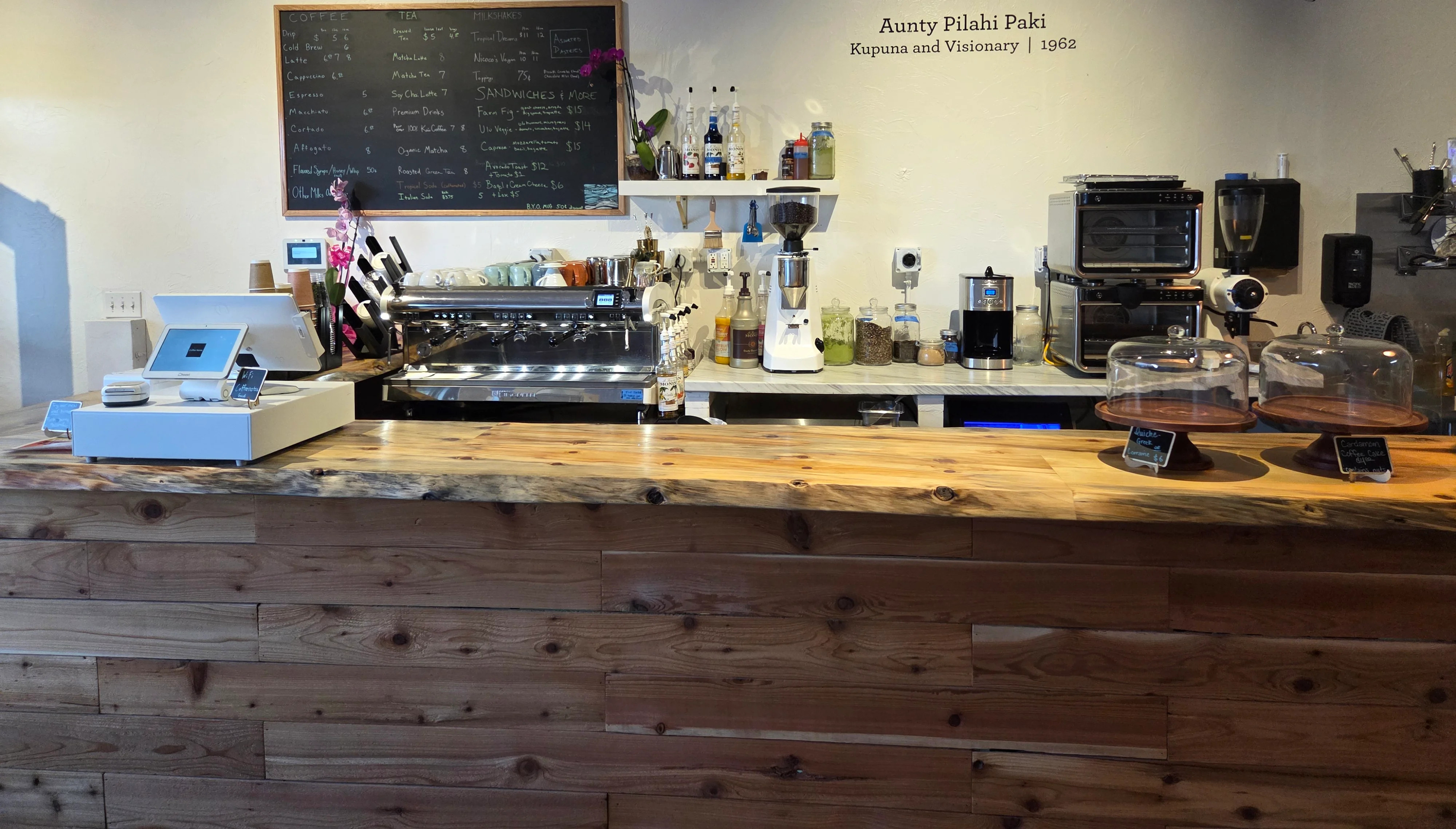 Cozy café interior with a wooden counter and menu board