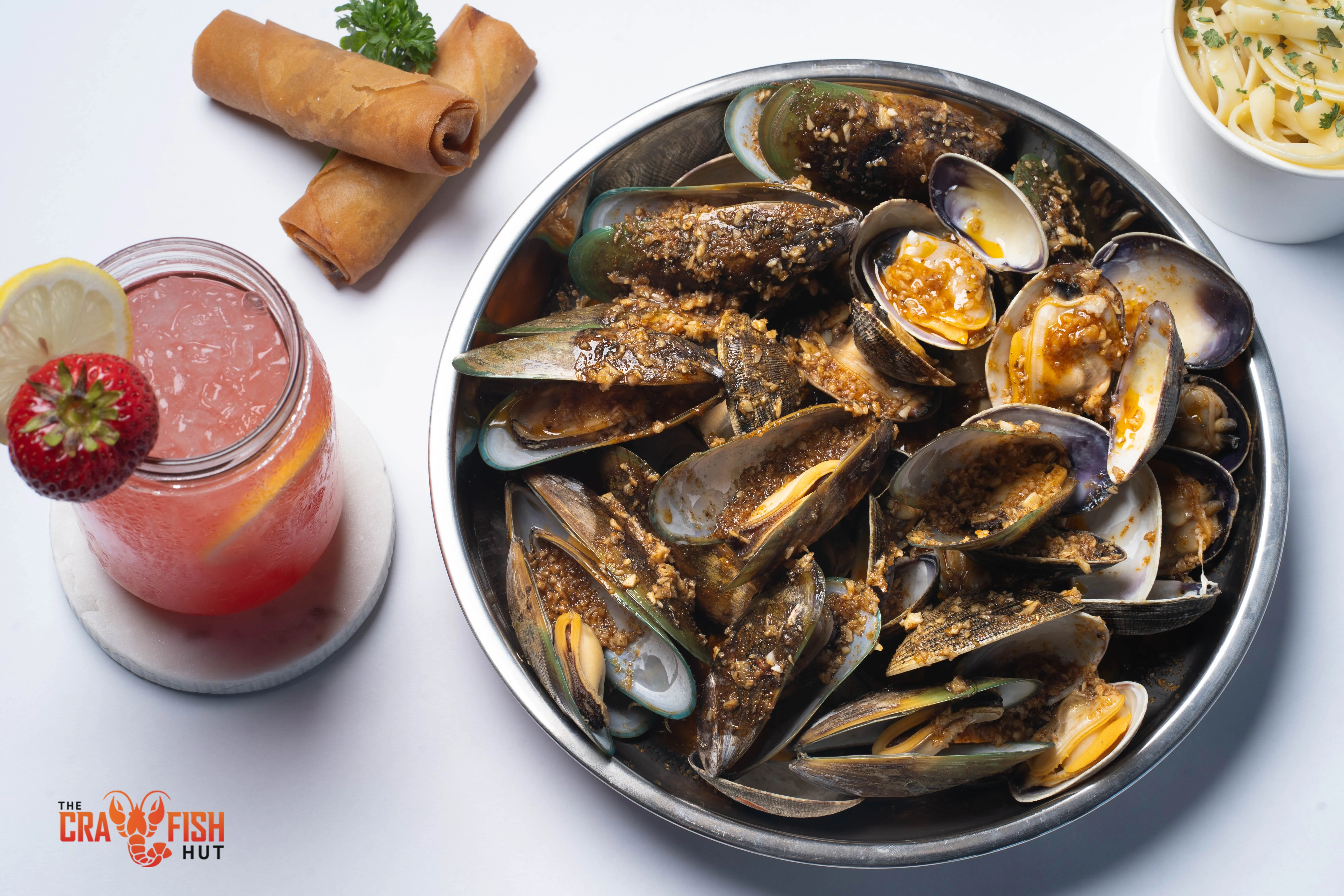 Garlic butter mussels served in a metal bowl