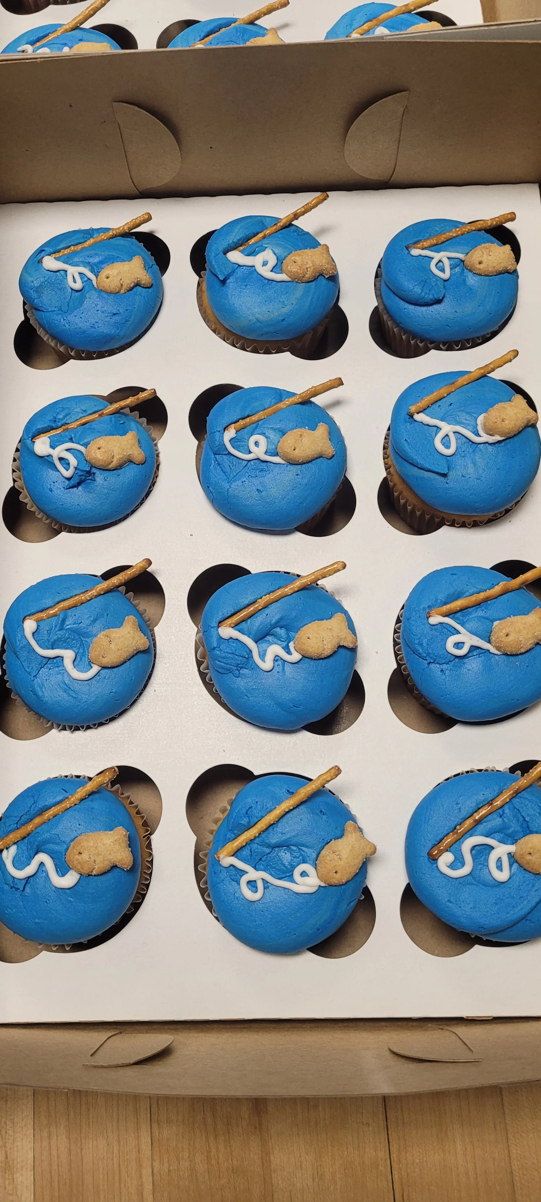 Creative blue cupcakes with fishing theme decorations
