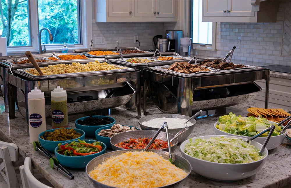 Buffet spread featuring Mexican taco bar with various toppings