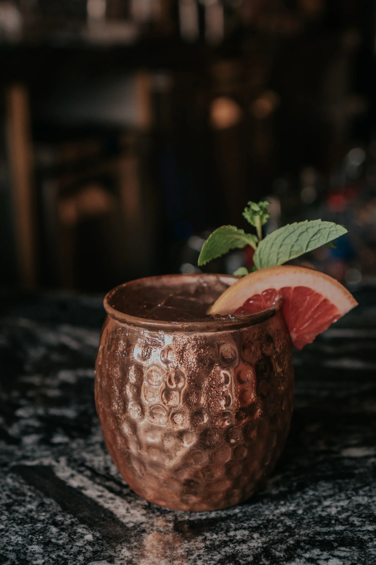 Drink in a copper cup with citrus and mint at Castro Indian Restaurant