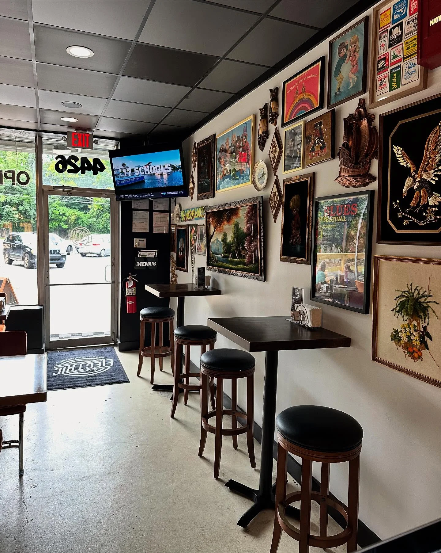 Cozy restaurant interior with eclectic wall art and bar seating