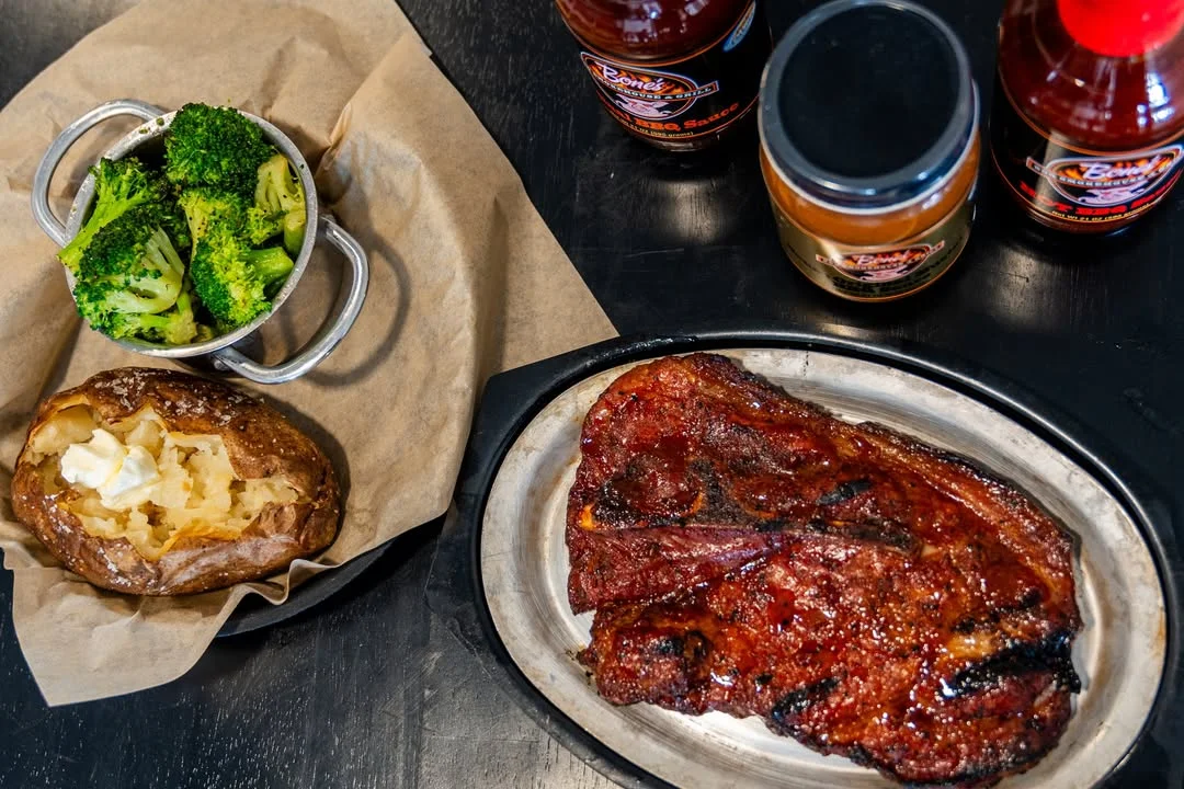 Grilled ribeye steak with baked potato and broccoli