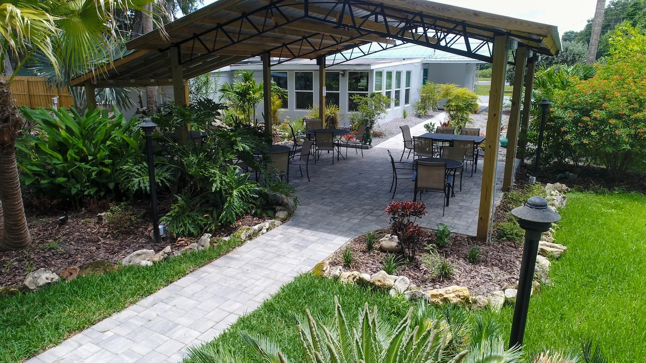 Outdoor dining area with lush greenery and seating