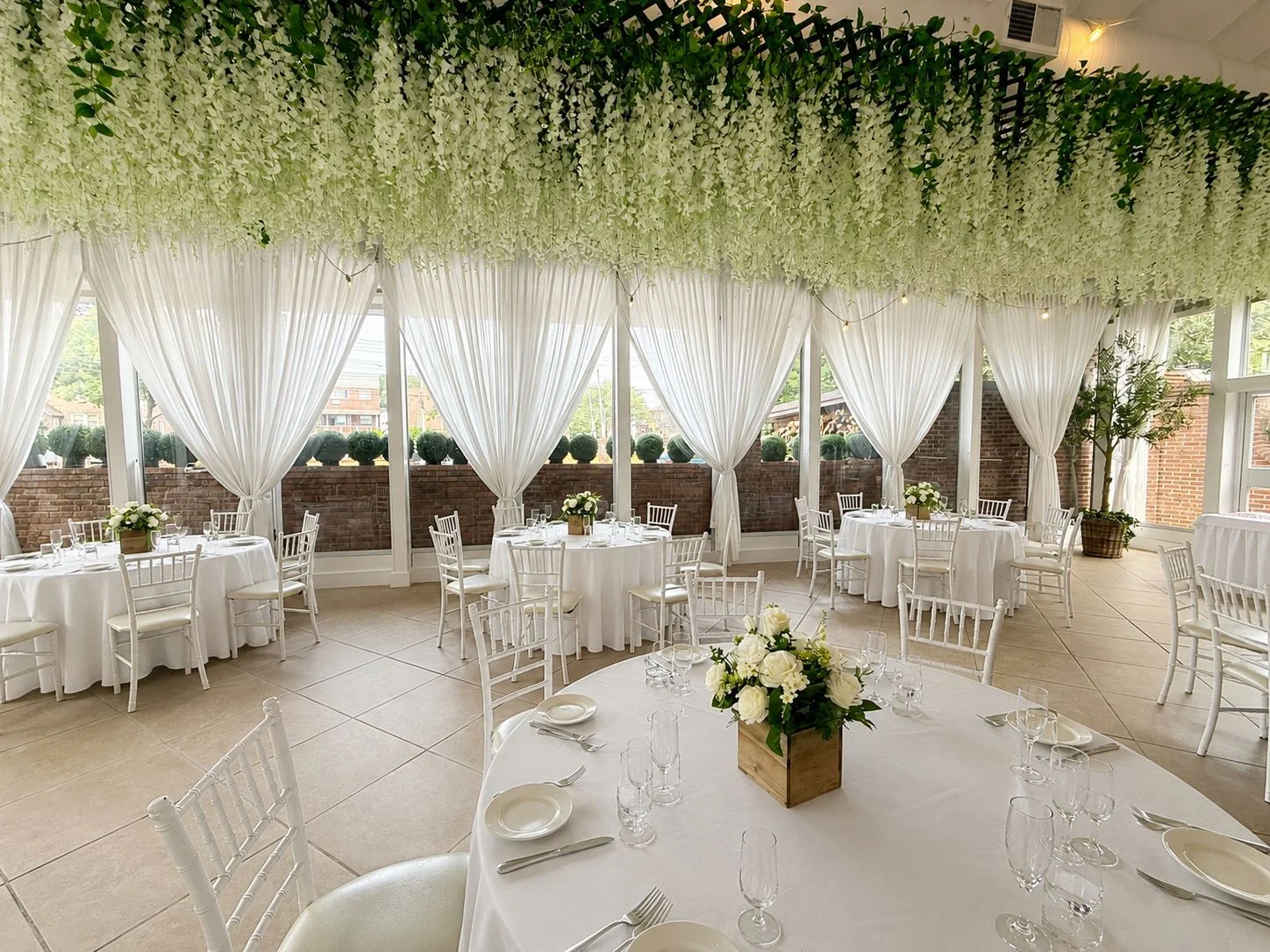Outdoor courtyard dining area with tables and greenery.