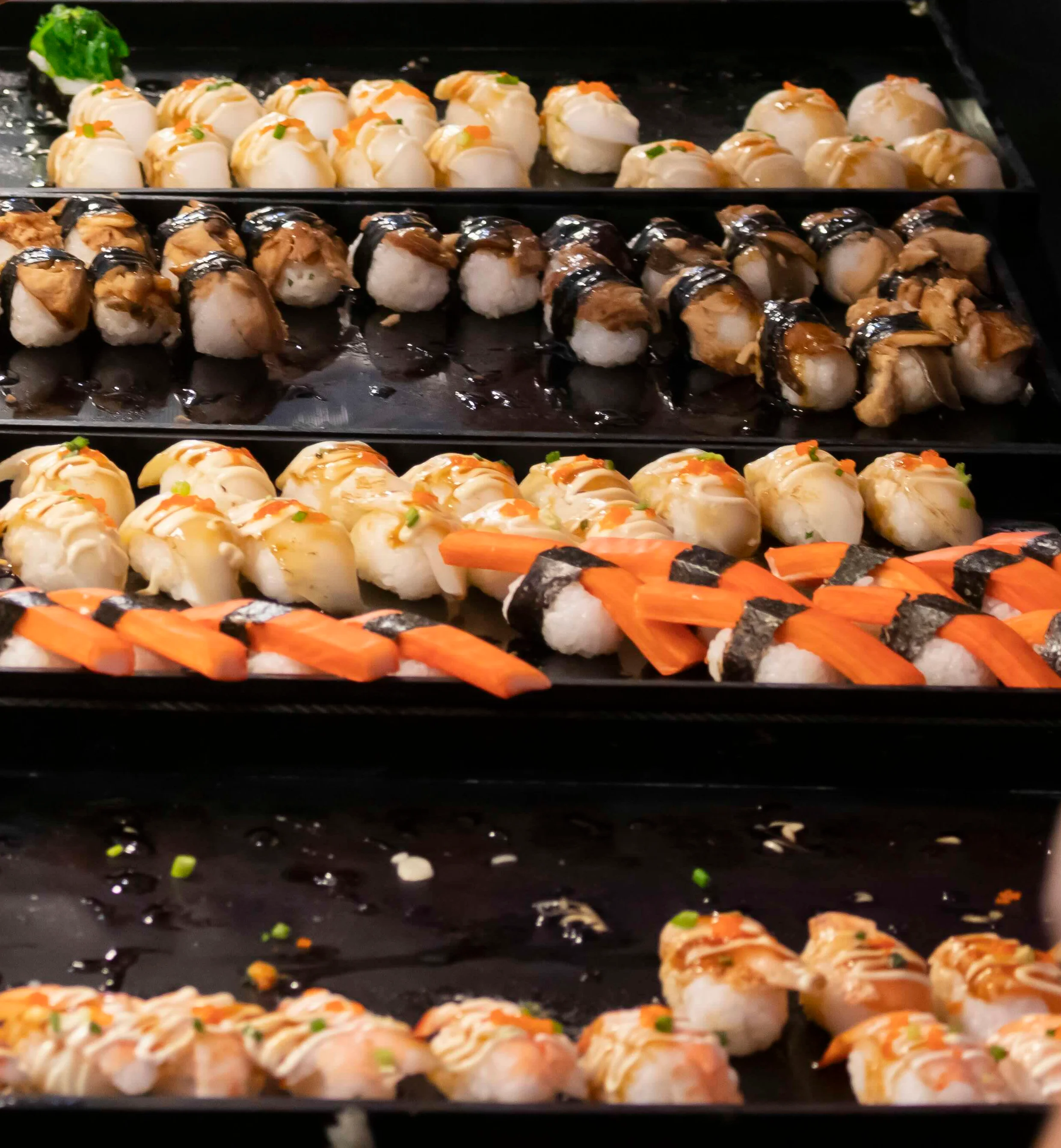 Assorted sushi platter featuring various rolls and nigiri