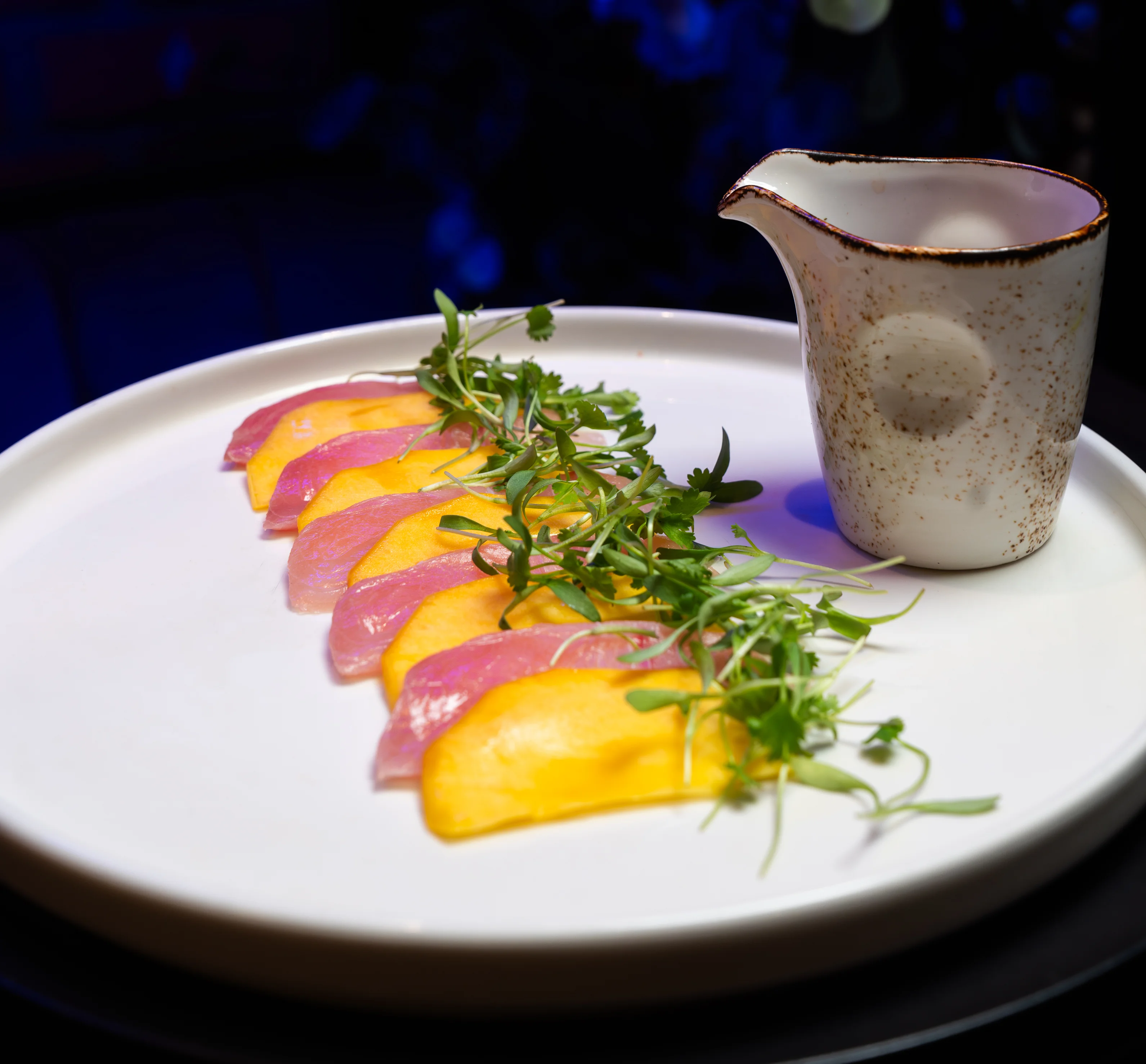 Sashimi platter with mango and microgreens