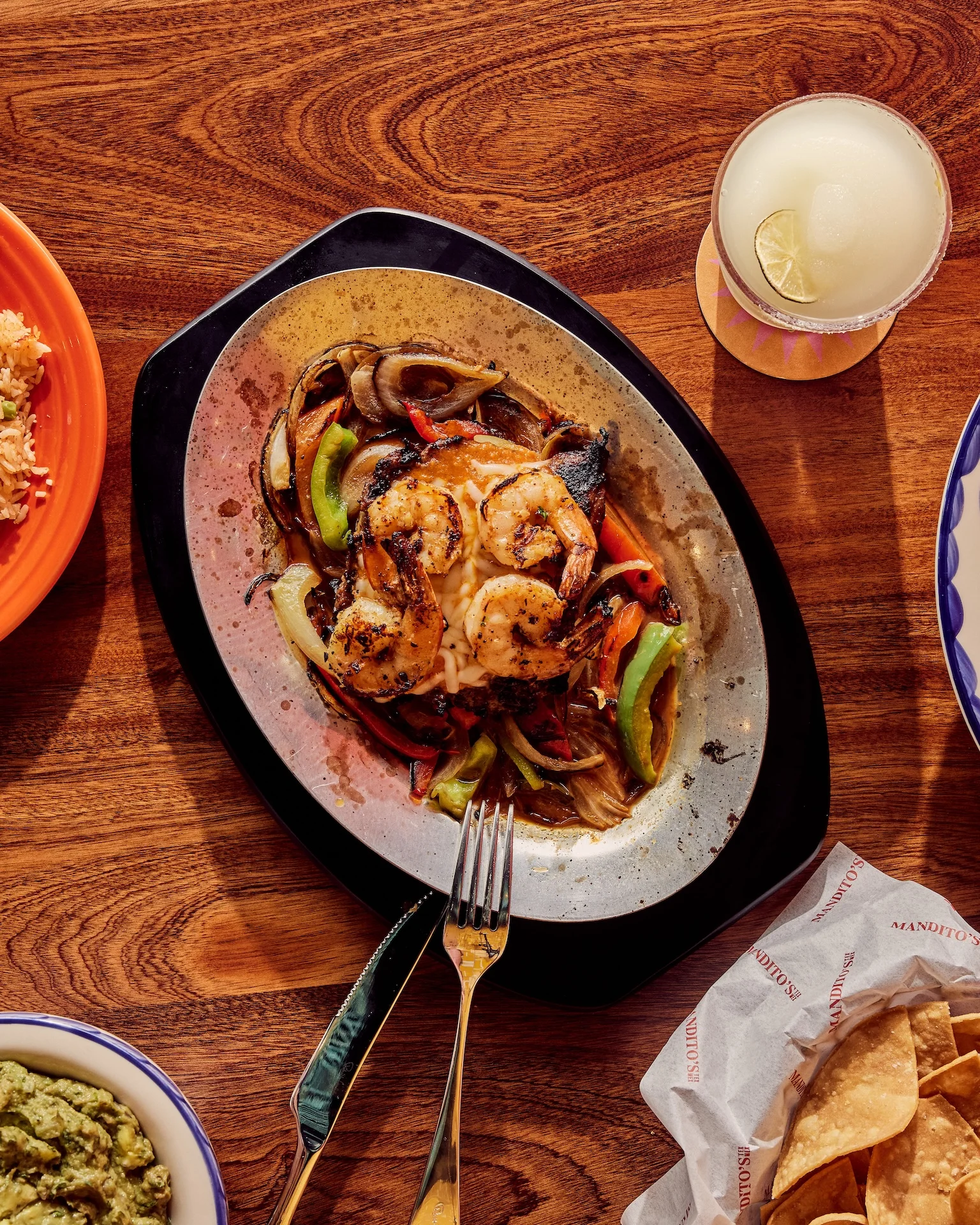 Sizzling shrimp fajitas served with peppers and onions