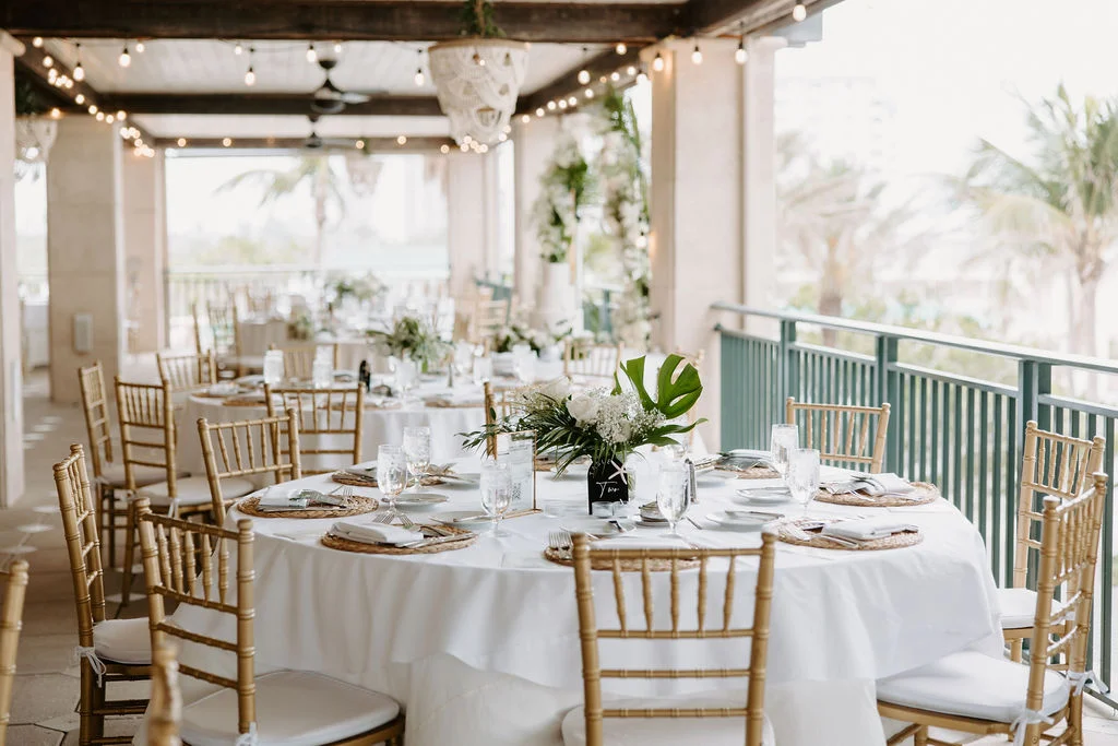 Elegant outdoor dining setup with tropical decor