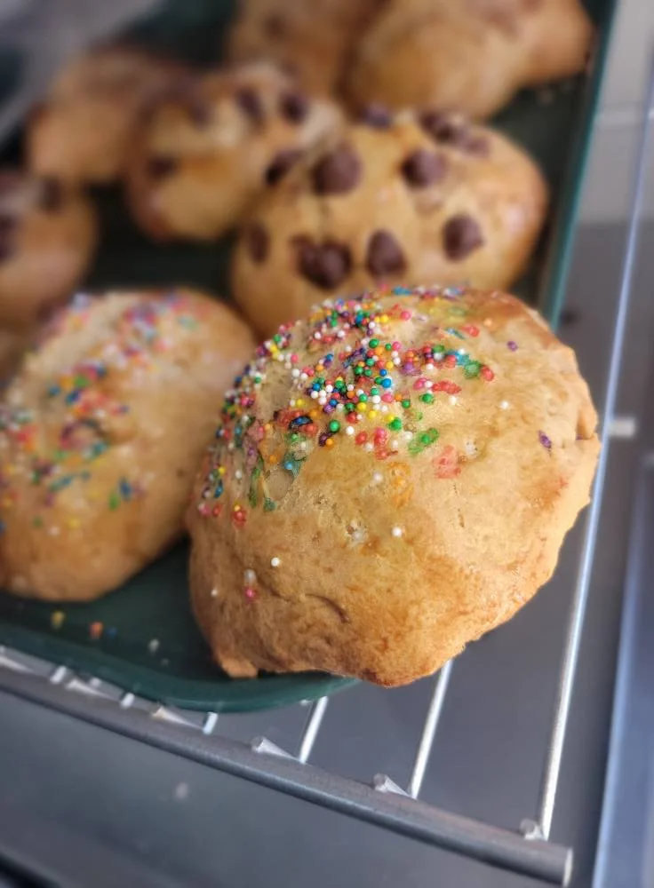 Colorful sprinkle cookies on a baking tray