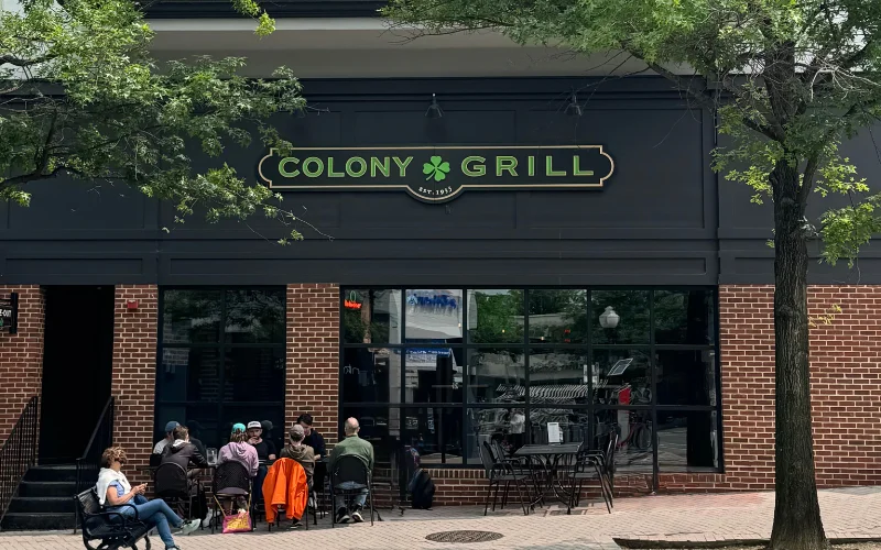 Exterior view of Colony Grill restaurant with outdoor seating