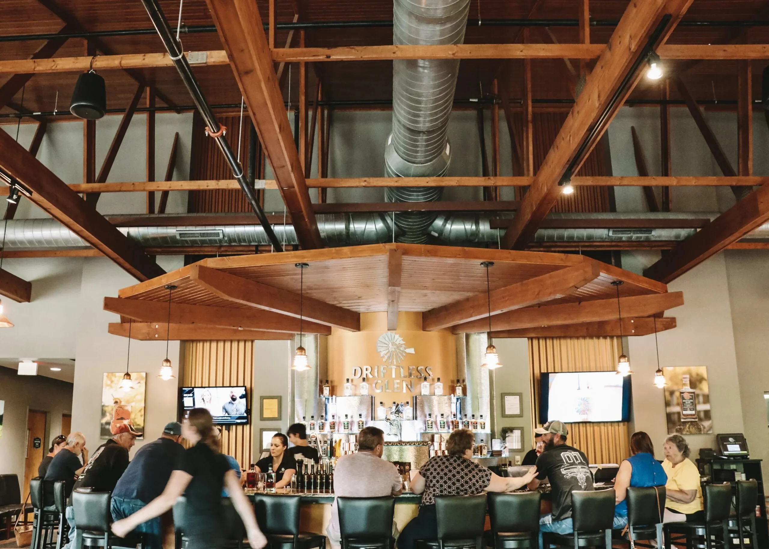 Front of the Driftless Glen bar filled with people during the day