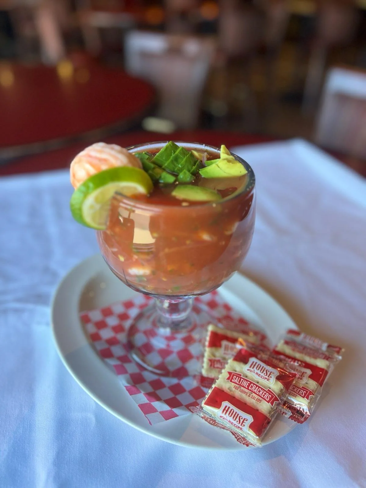 Refreshing Mexican shrimp cocktail in a glass with garnishes