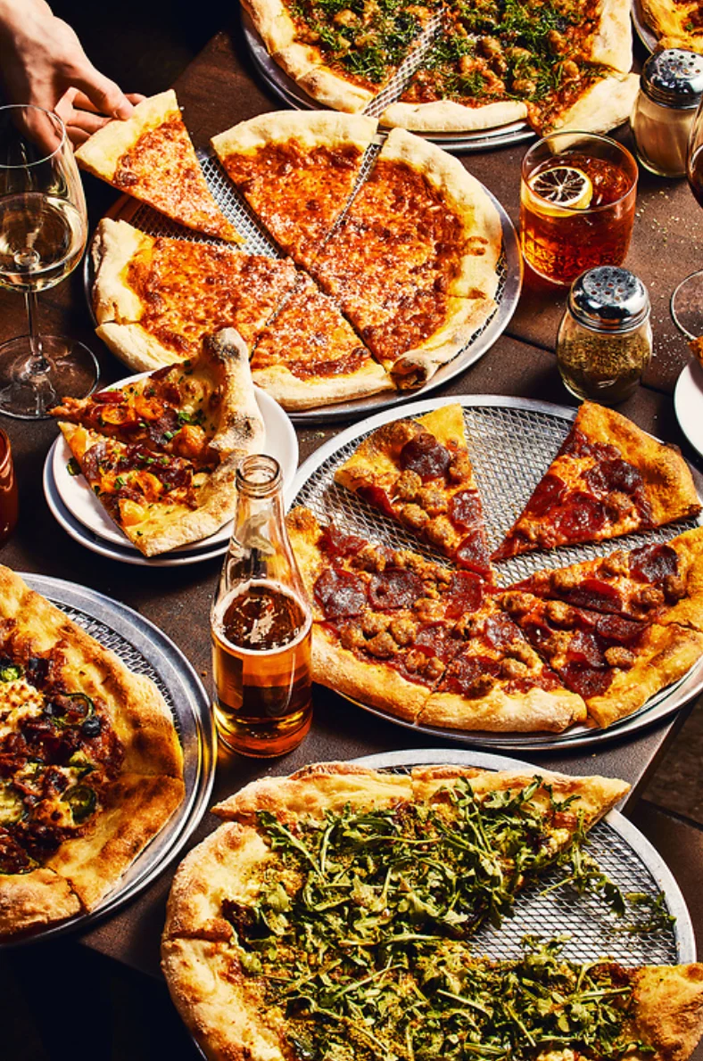 Variety of gourmet pizzas served in a vibrant restaurant setting