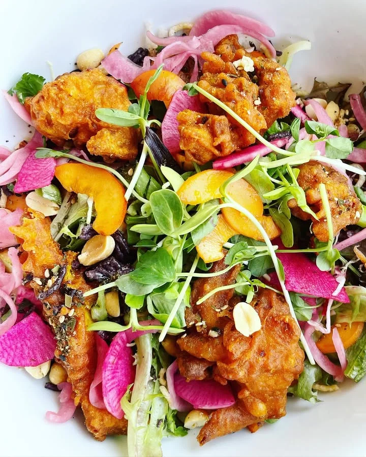 Crispy Indian bhaji salad with fresh greens and vibrant toppings
