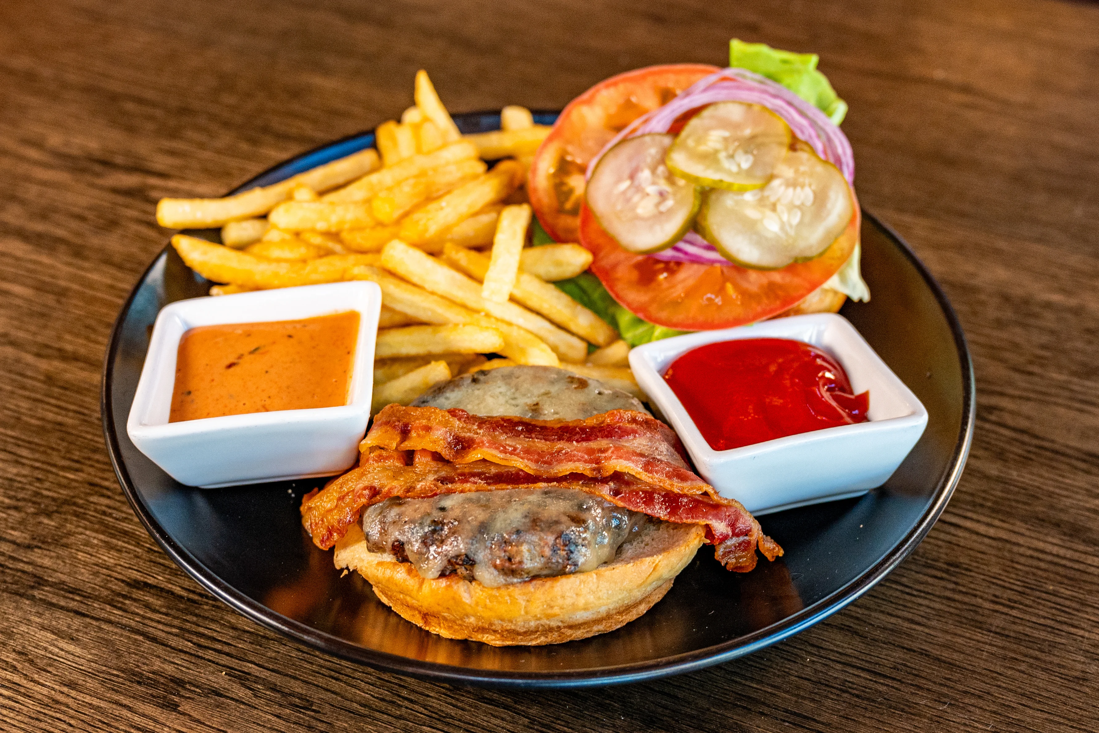 Classic American cheeseburger with fries and condiments