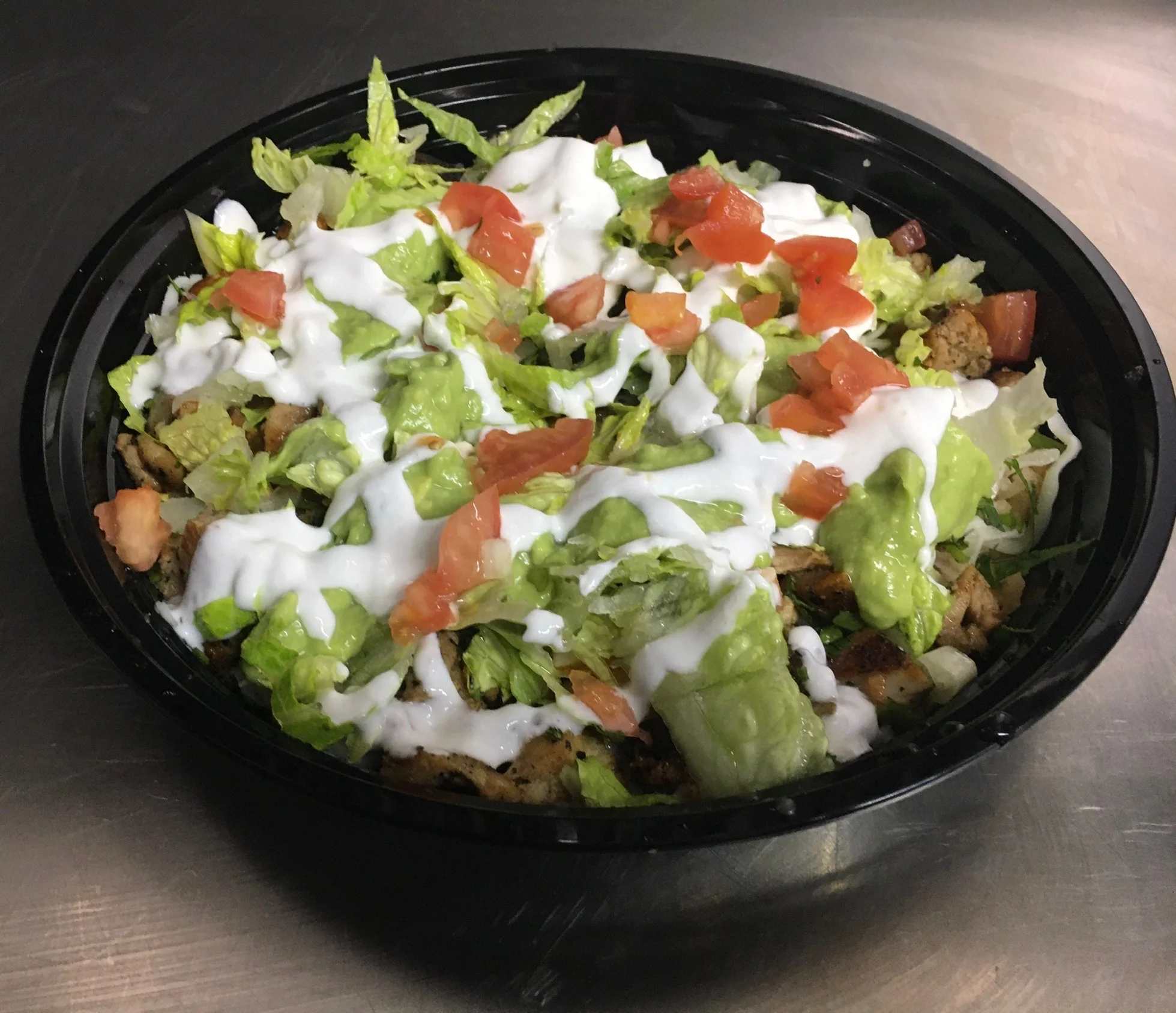 Mexican chicken burrito bowl with fresh toppings