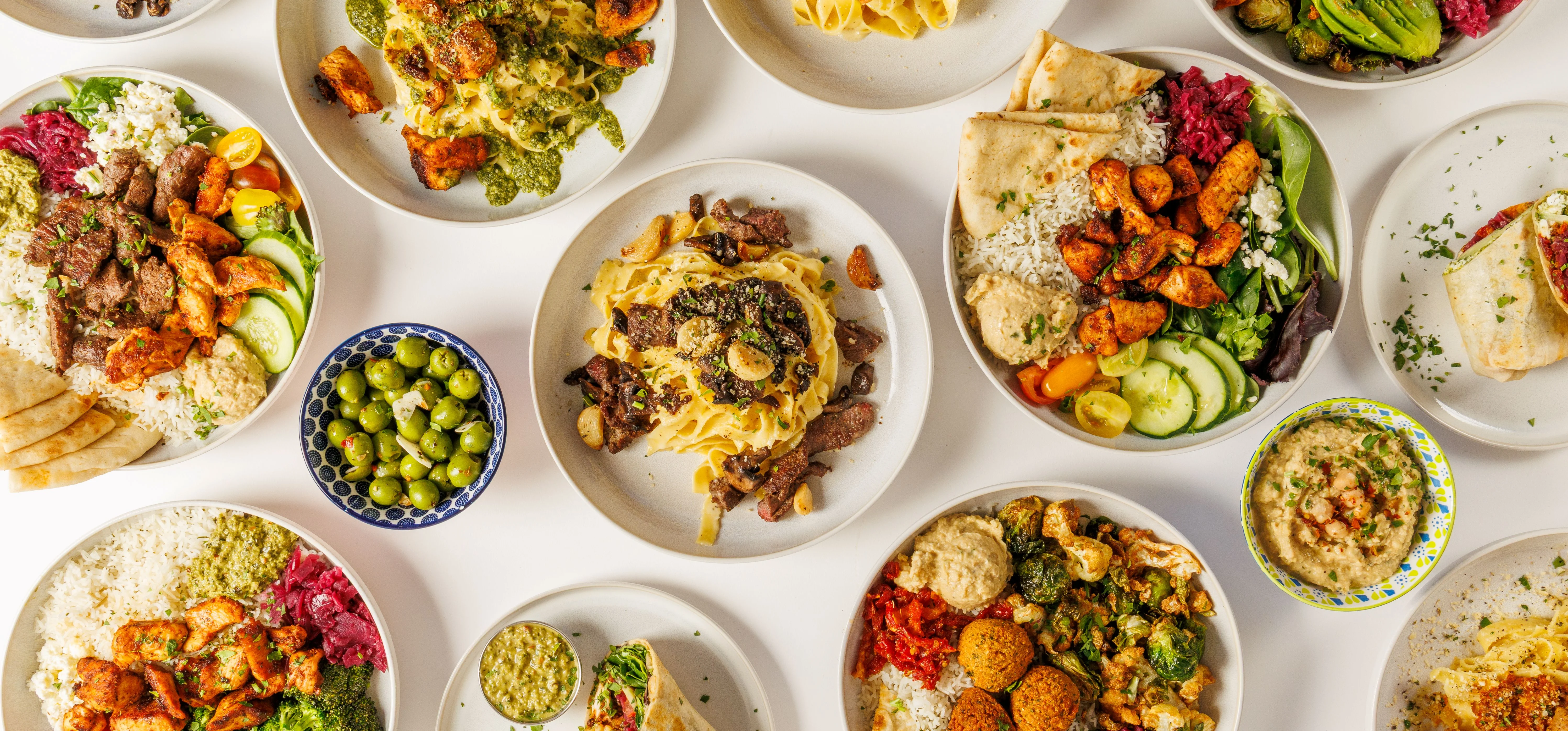 Variety of Mediterranean grain bowls and pasta dishes