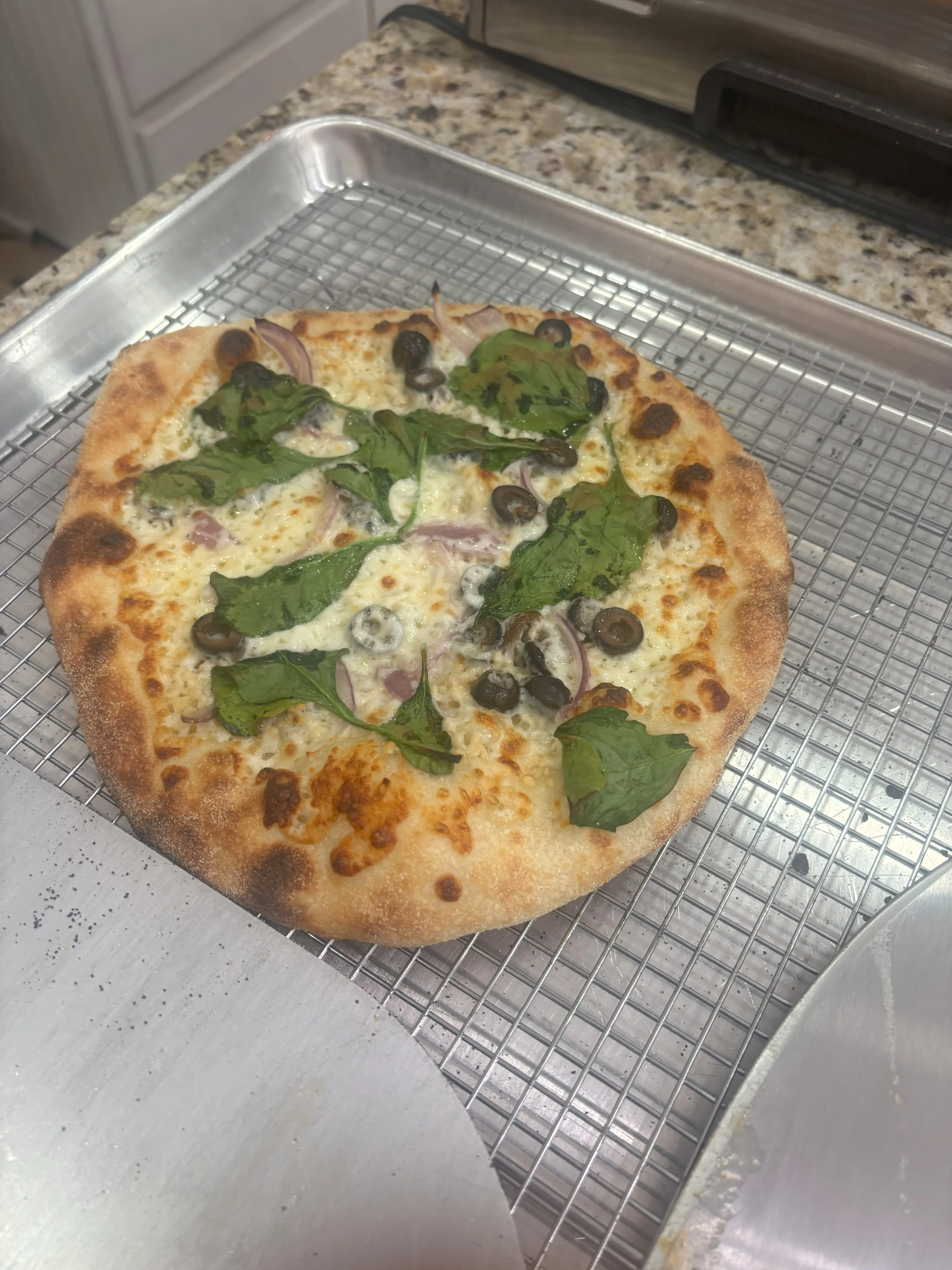 Freshly baked Margherita pizza on a cooling rack