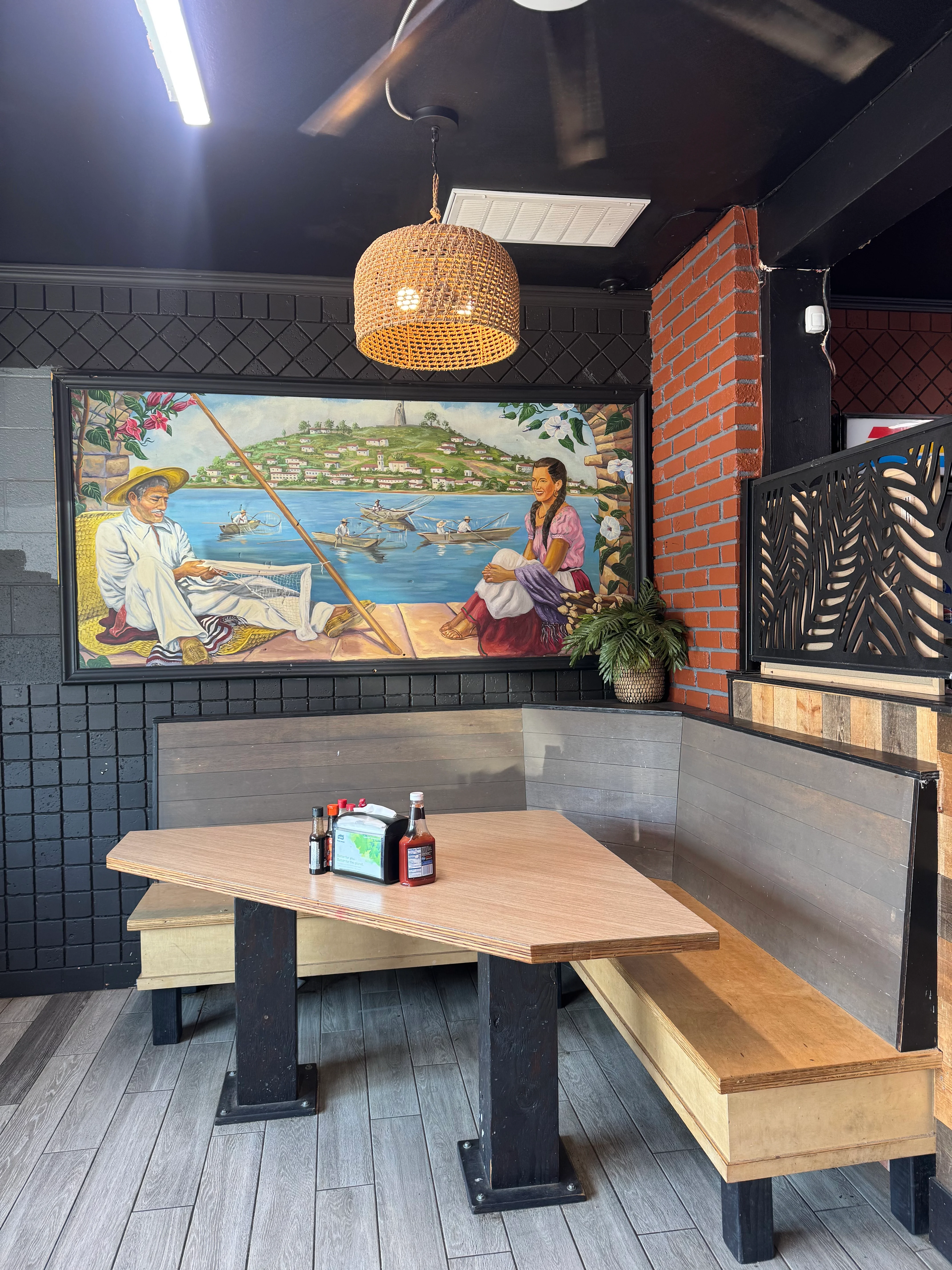 Cozy restaurant interior with mural and warm lighting