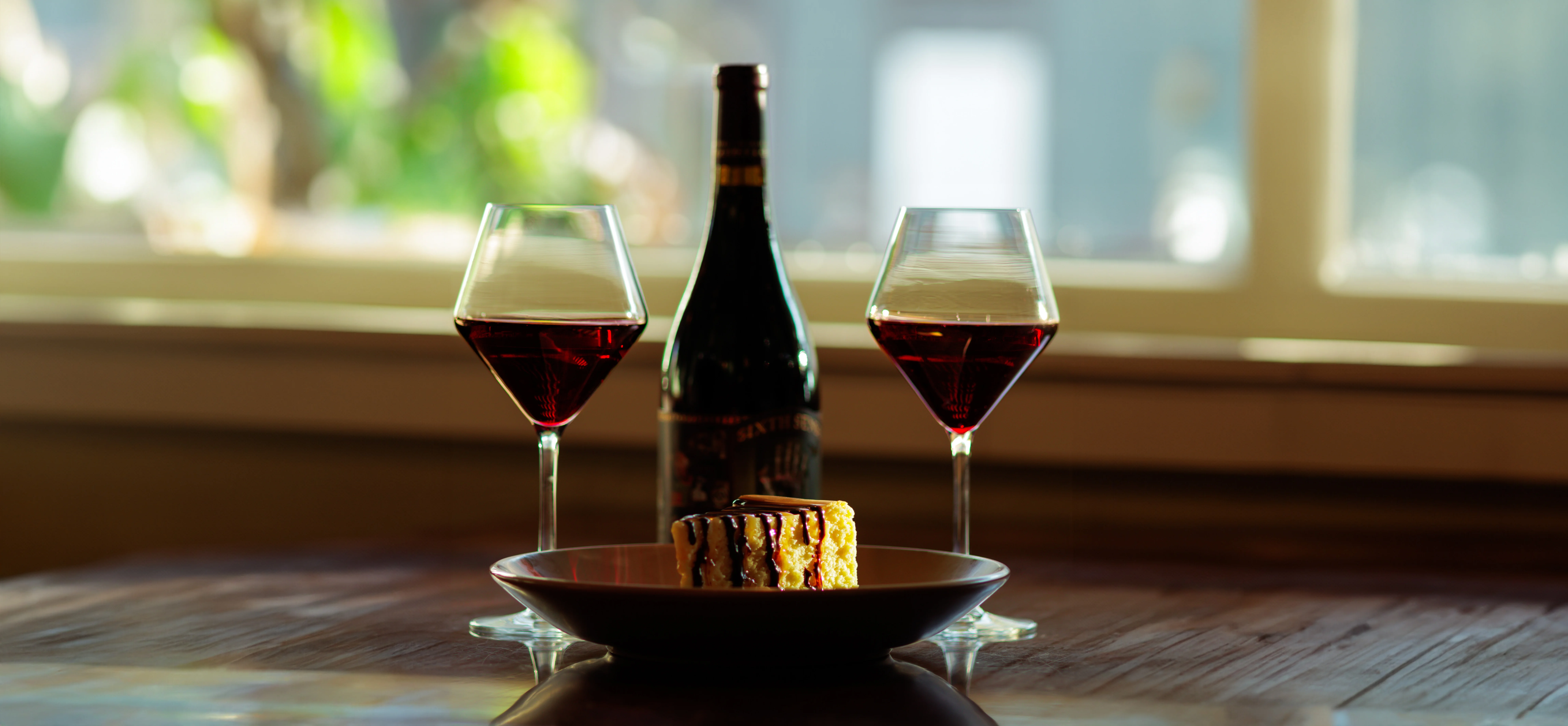 Romantic setting with red wine and dessert