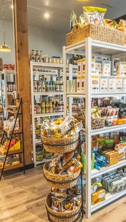 Well-stocked grocery store interior with shelves and baskets
