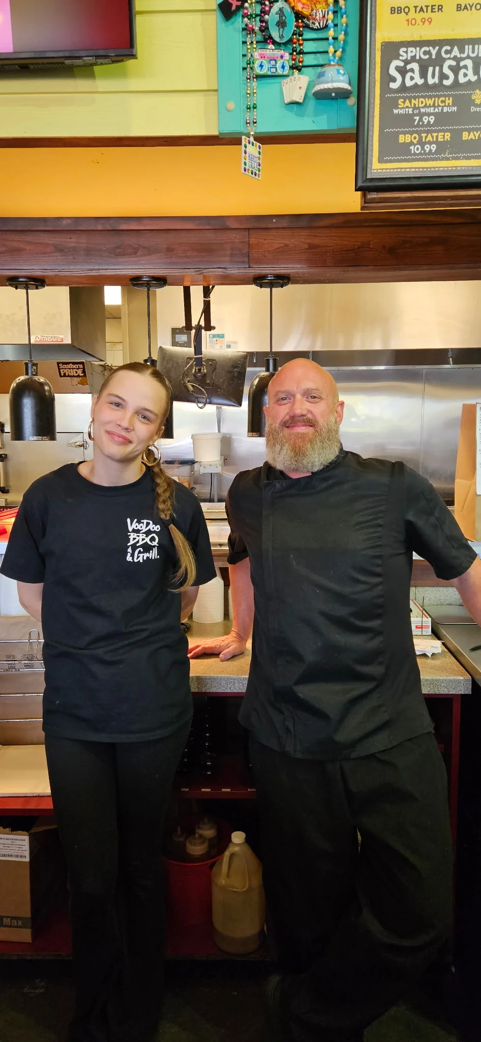 VooDoo BBQ Pensacola team members in the kitchen, representing the friendly culture and hiring opportunities at the restaurant.