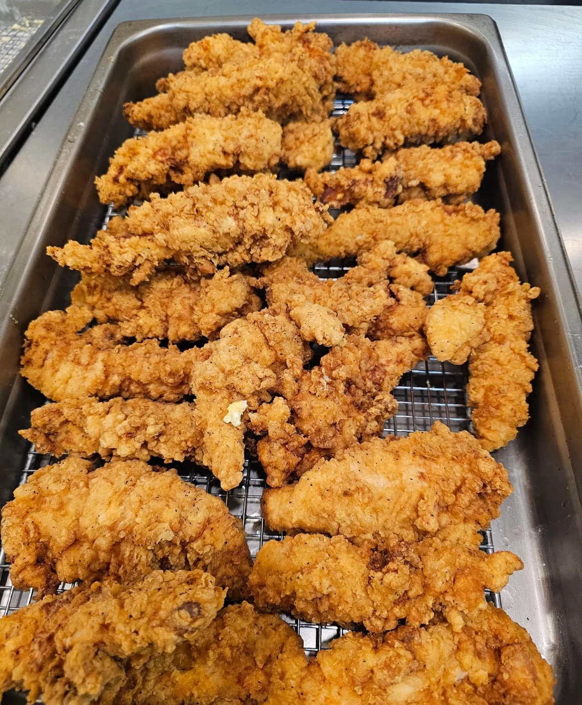 Crispy Southern fried chicken tenders on a serving tray