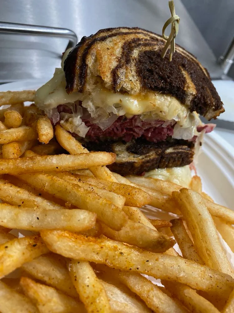 Delicious gourmet burger with fresh toppings on a wooden table