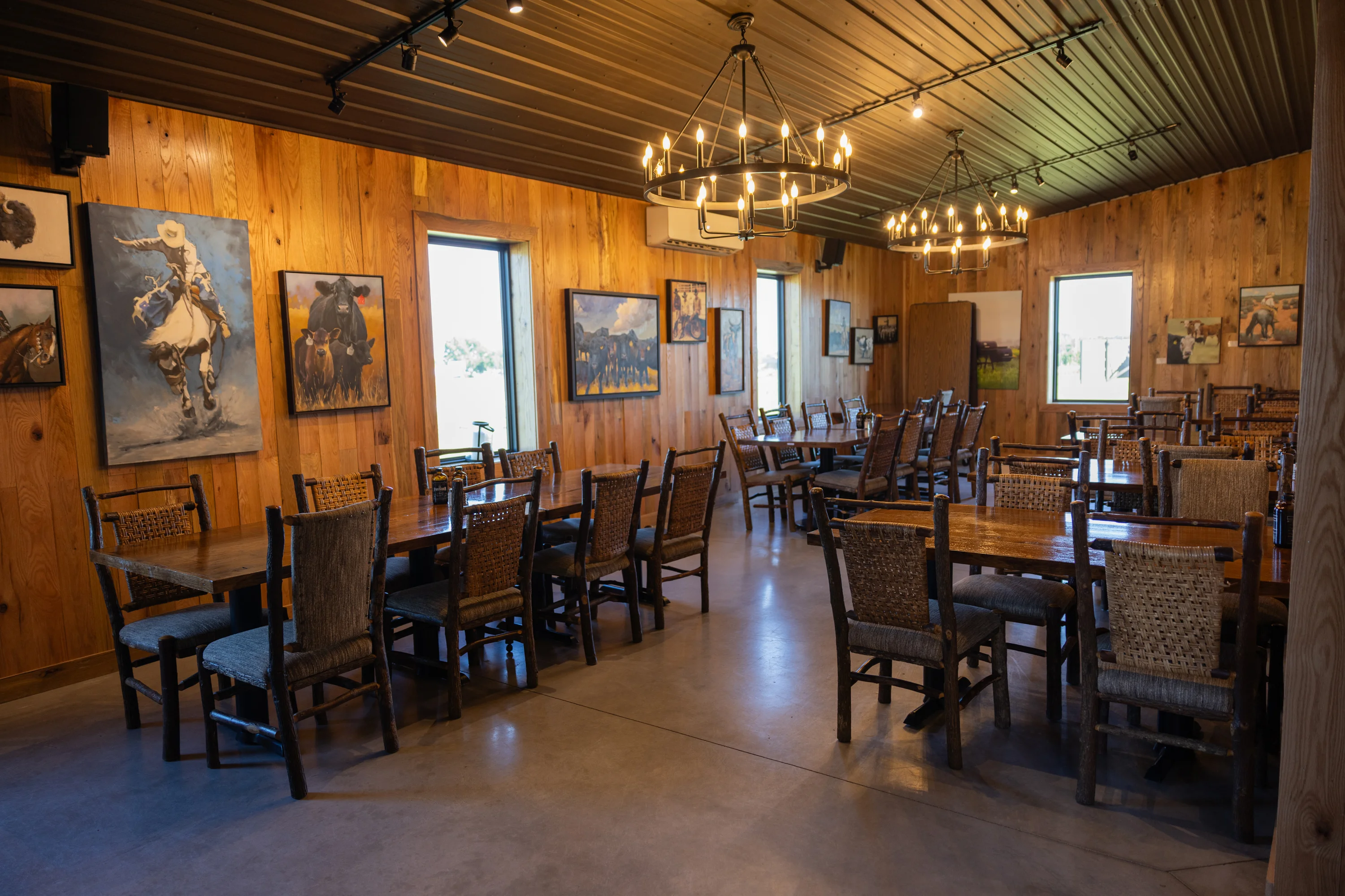 Interior of a rustic restaurant with wooden decor and artwork.