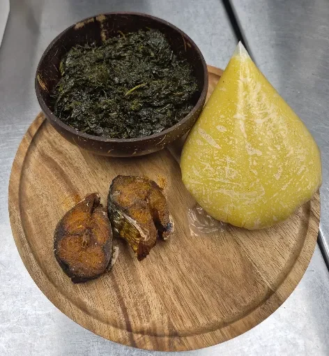 Nigerian suya with fried plantains and fresh vegetables