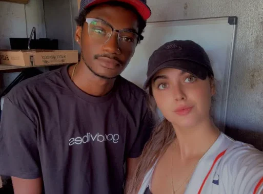 Two restaurant staff members posing together in a casual setting