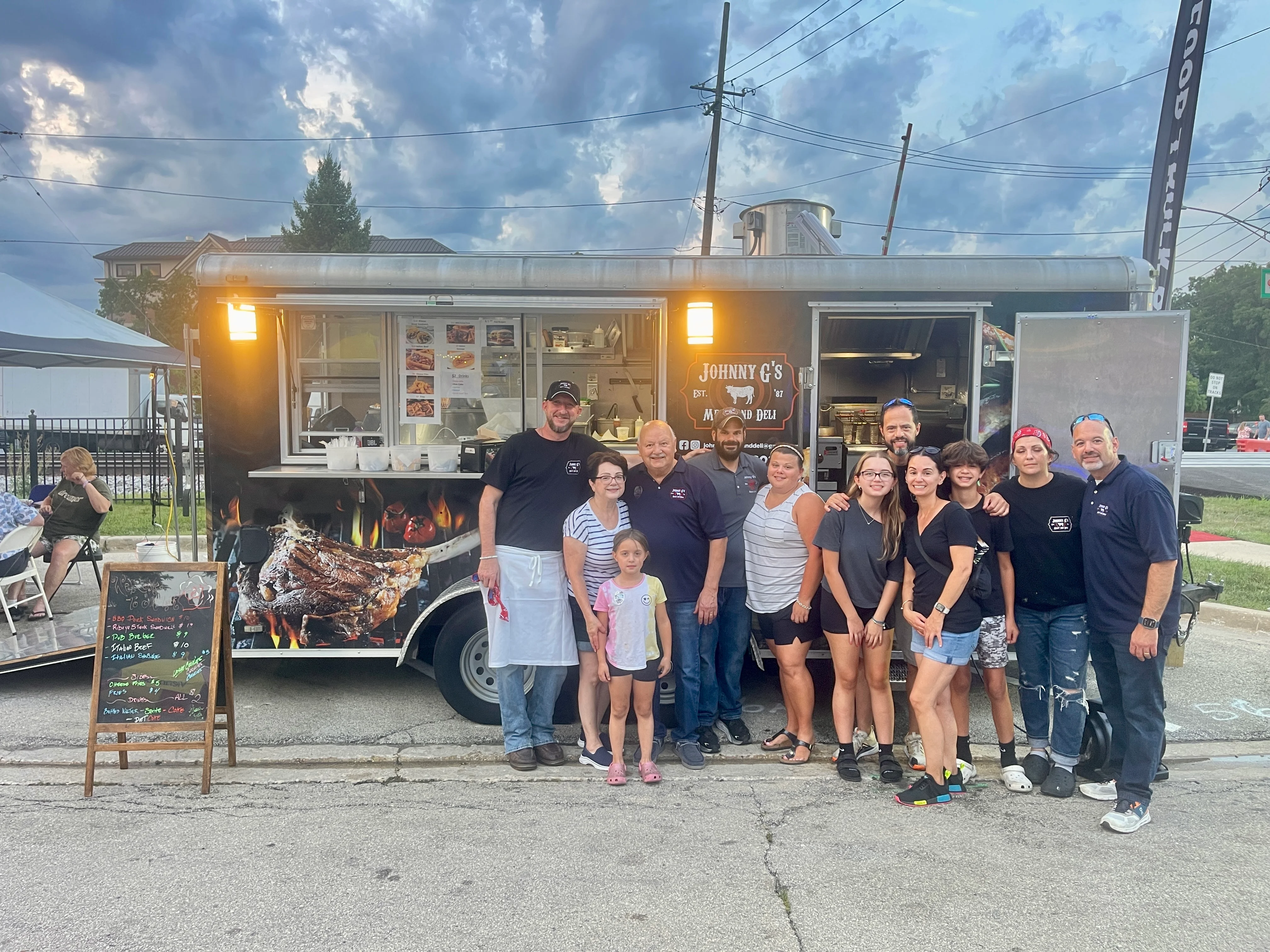Food truck team in front of Johnny's BBQ trailer