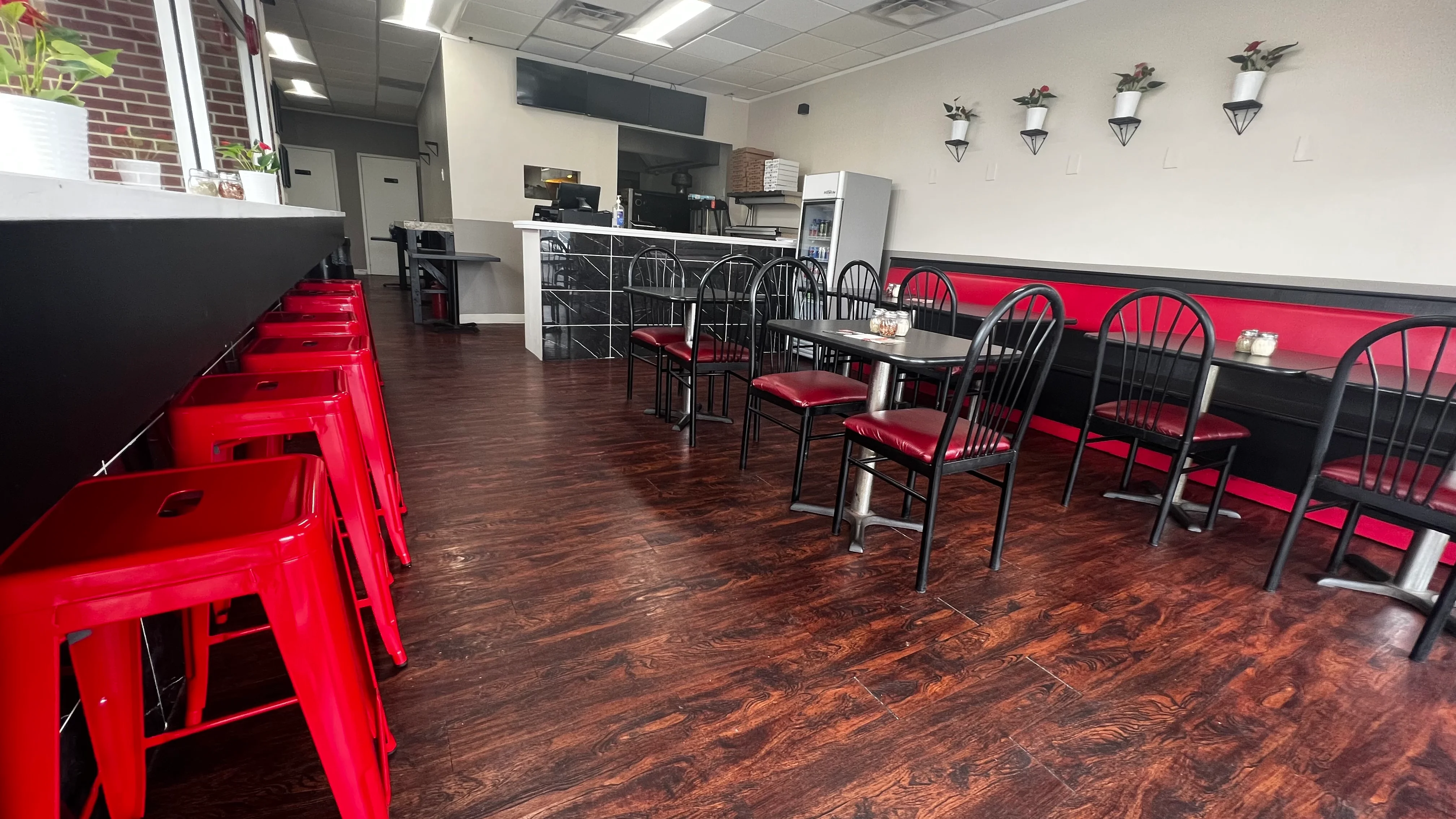 Cozy restaurant interior with red accents and modern seating