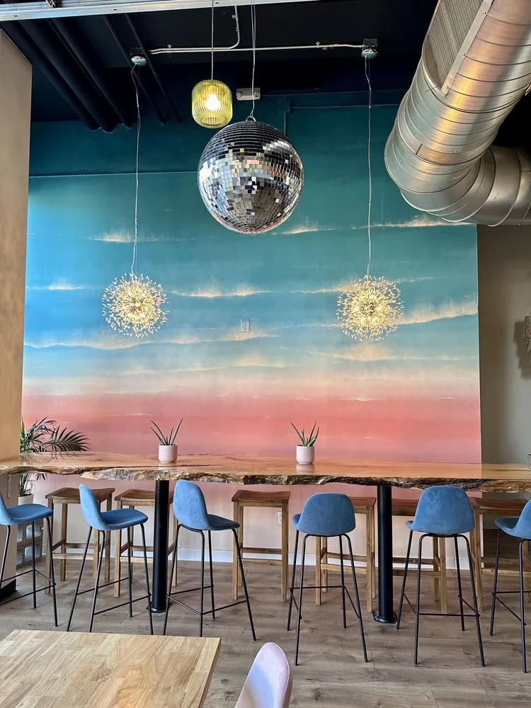 Stylish restaurant interior with colorful mural and modern lighting