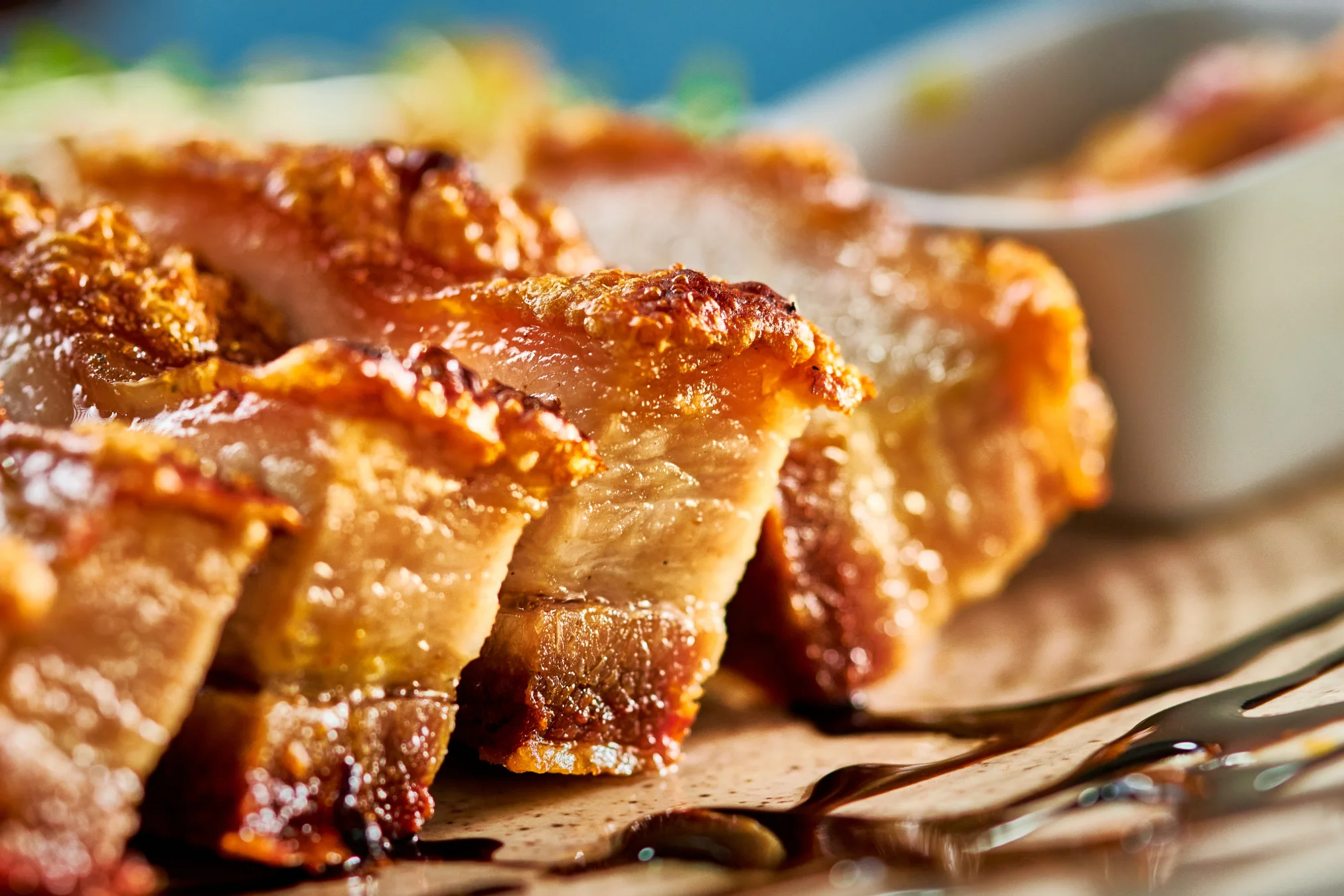 Crispy Filipino lechon belly served on a wooden platter