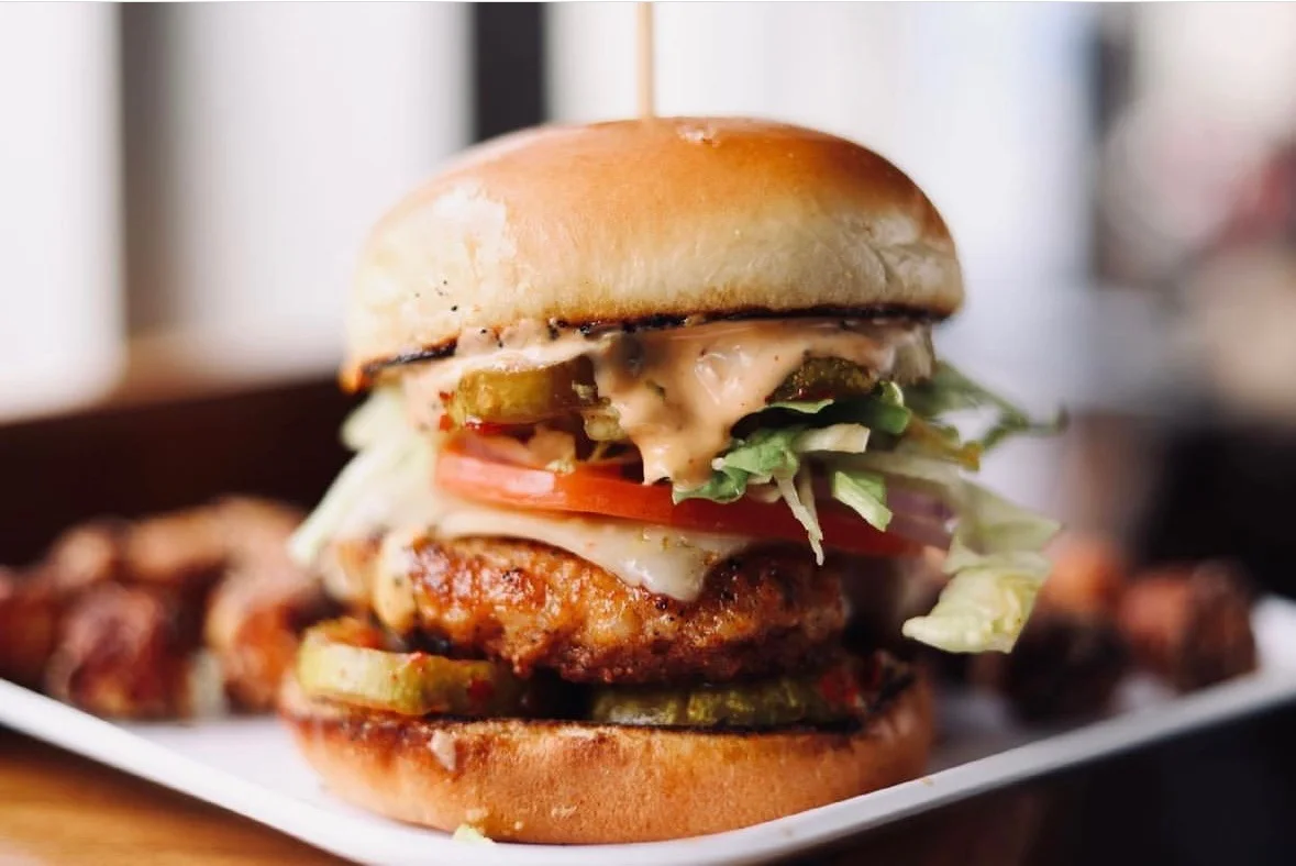 Crispy chicken sandwich with pickles and fresh vegetables