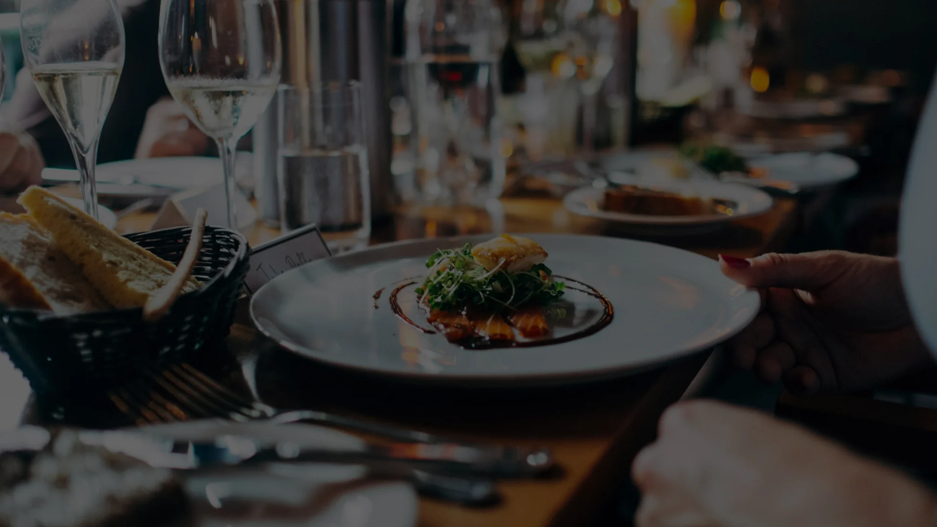 Elegant plated fish dish with microgreens in a fine dining setting