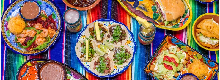 Colorful Mexican taco platter with shrimp and sides