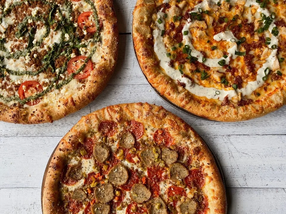 Three gourmet pizzas featuring unique toppings