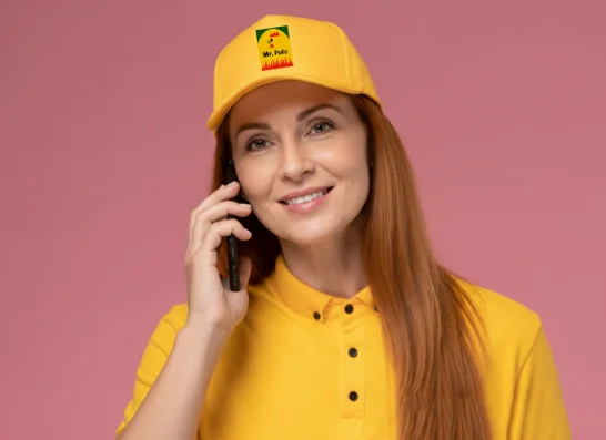 Smiling woman in yellow uniform talking on the phone