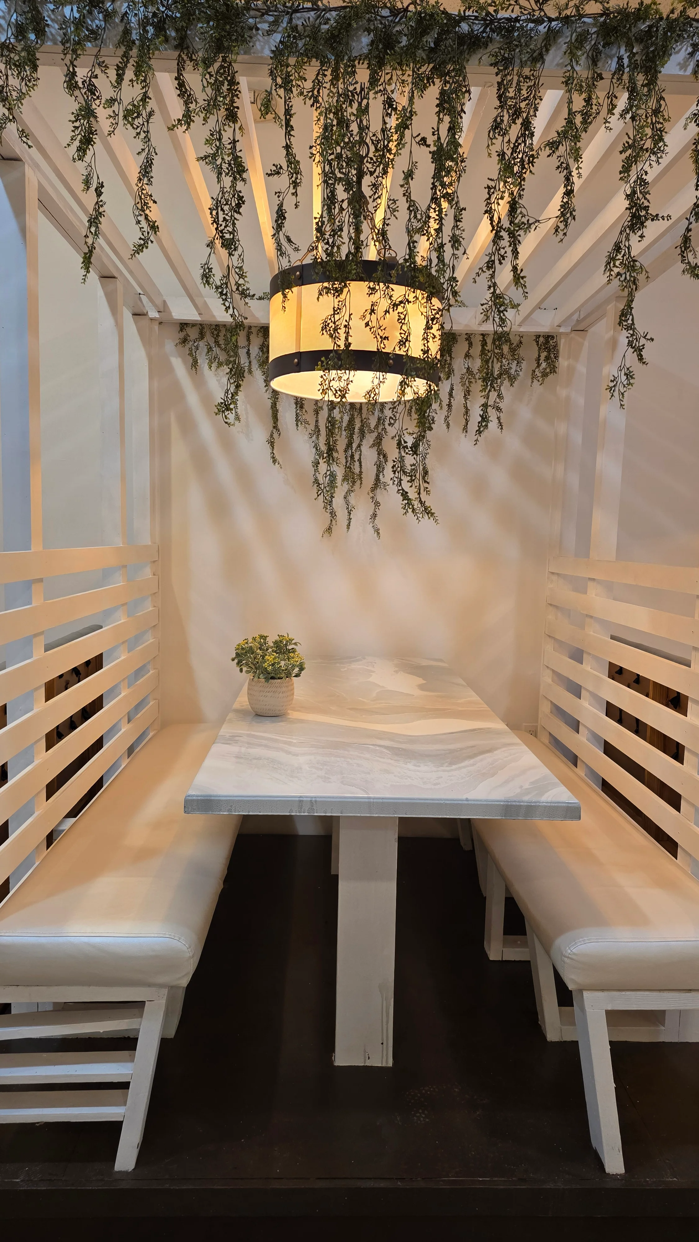 Cozy restaurant booth with greenery and warm lighting