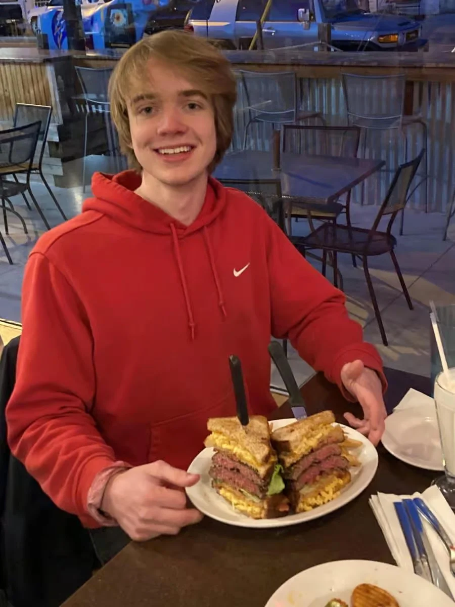 Giant stacked pastrami sandwich on toasted bread