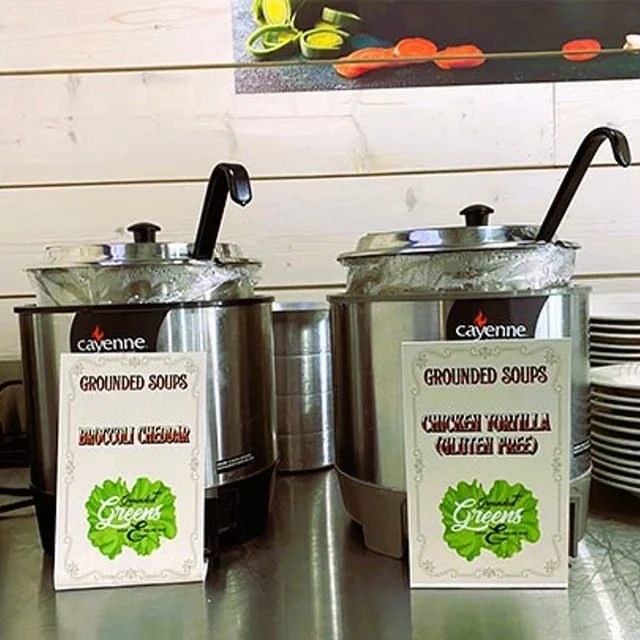 Two soup pots featuring broccoli cheddar and chicken tortilla soups