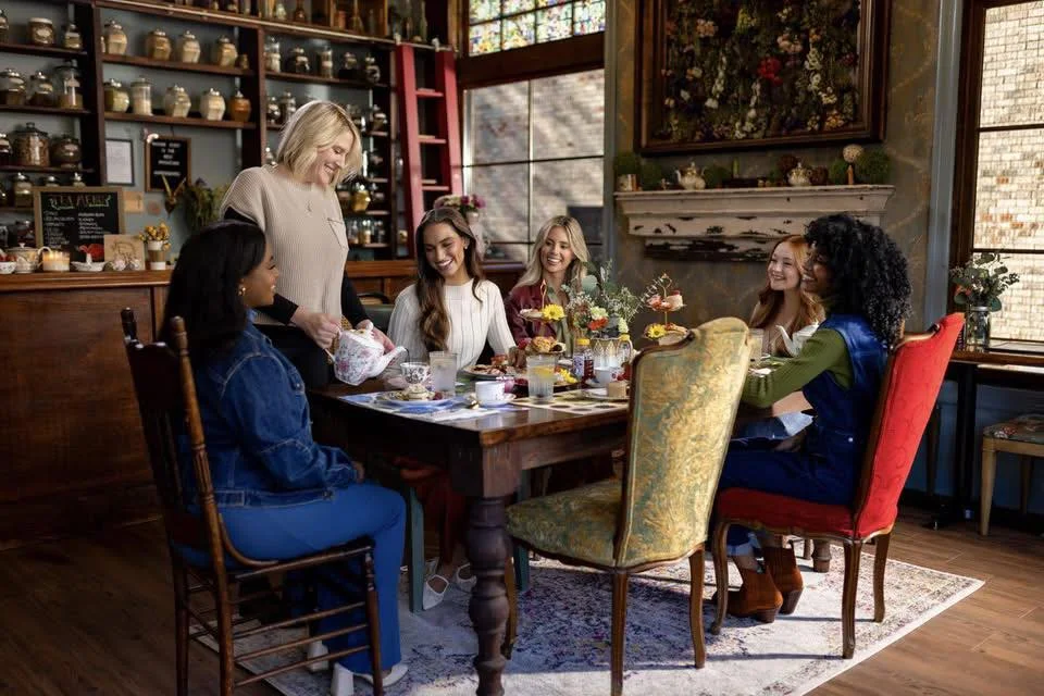 Group of friends enjoying tea in a cozy cafe setting