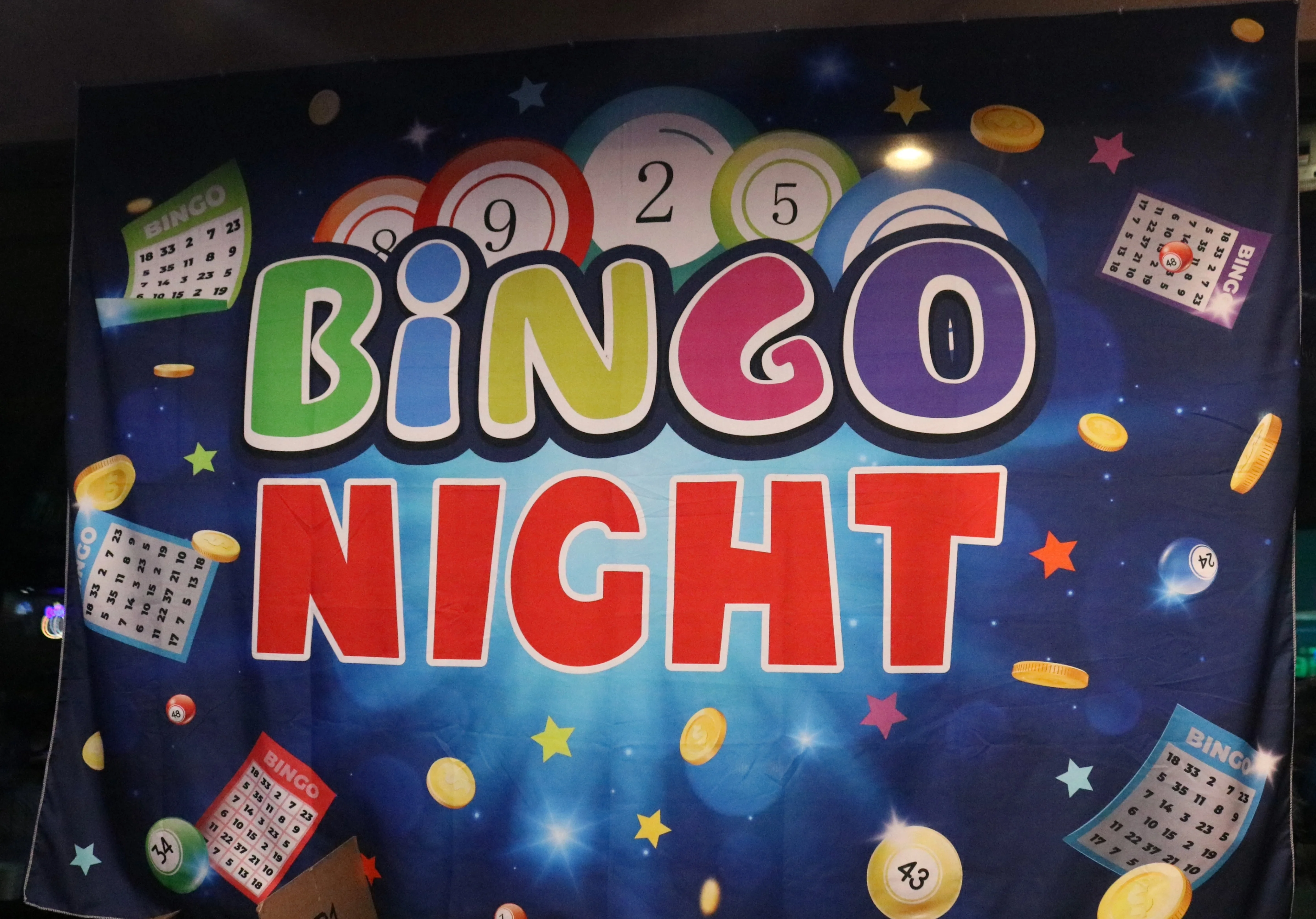 Colorful Bingo Night banner with game cards and tokens