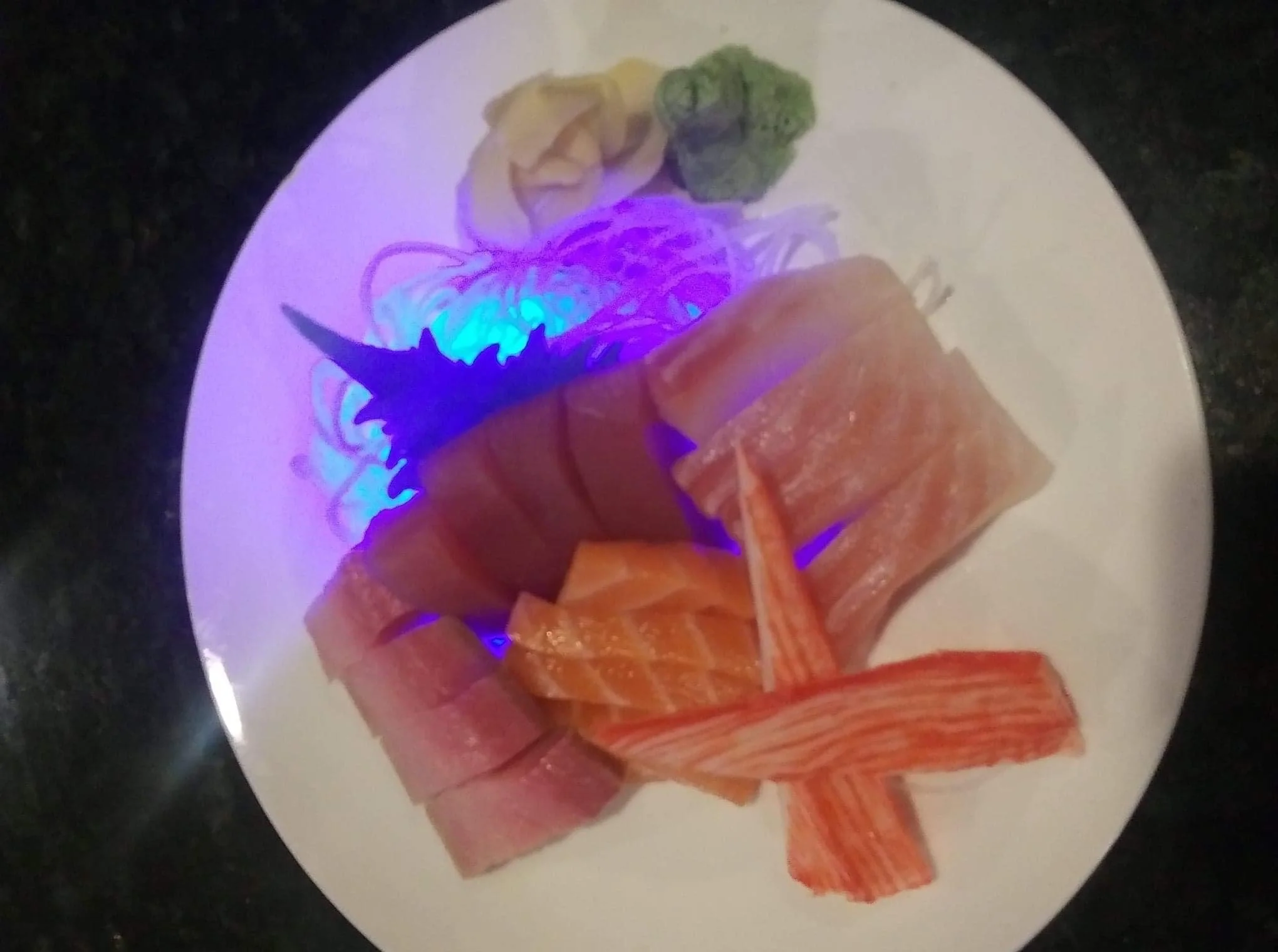 Assorted Japanese sashimi platter with wasabi and pickled ginger
