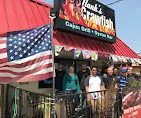 An exterior view of a seafood restaurant, featuring an American flag and a sign indicating its name.