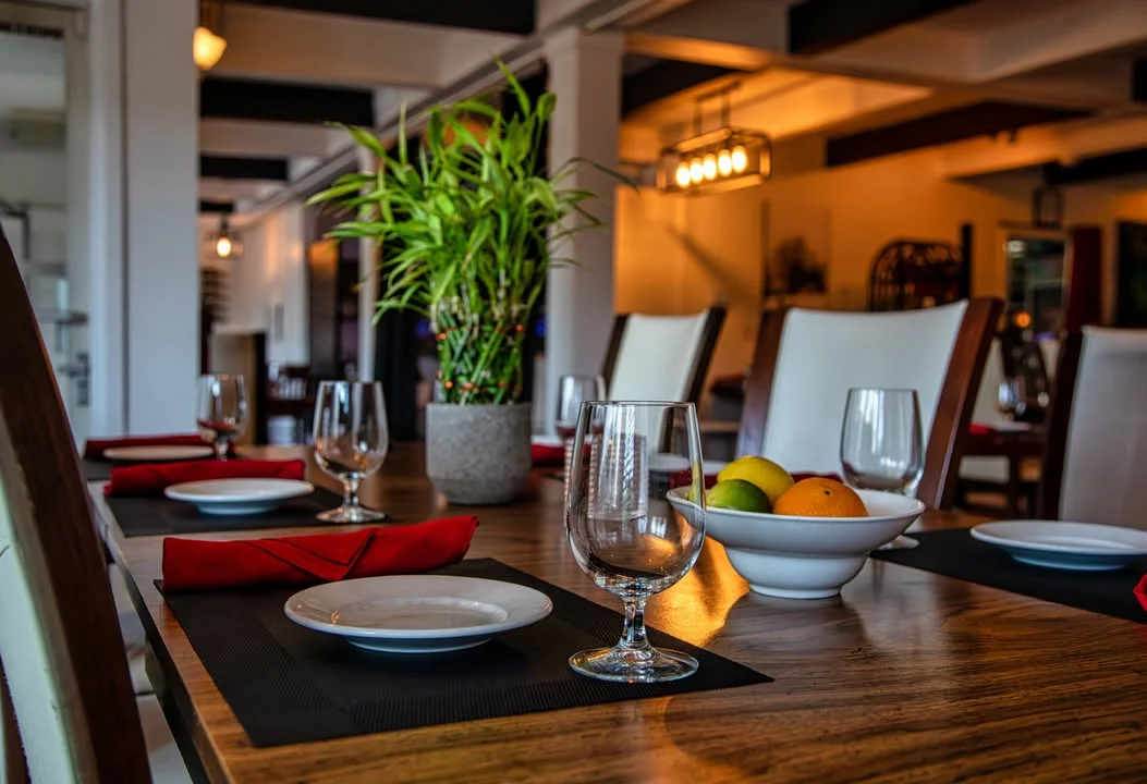 Elegant restaurant dining setup with plants and glassware