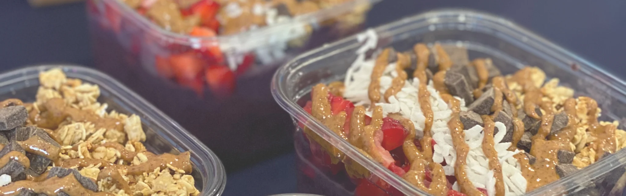 Colorful acai bowls topped with fruits and granola